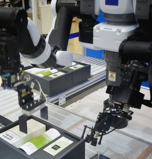 a robotic arm picking parts on a production line