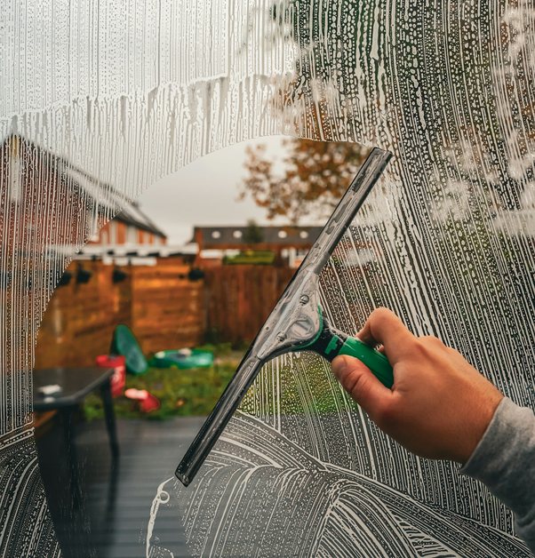 a squeegee pulled down a soapy pane of glass