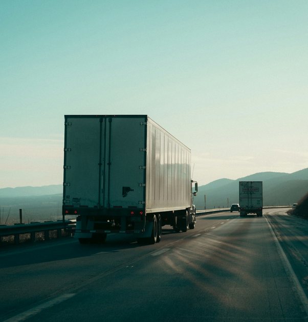a semi trailer truck on an open highway
