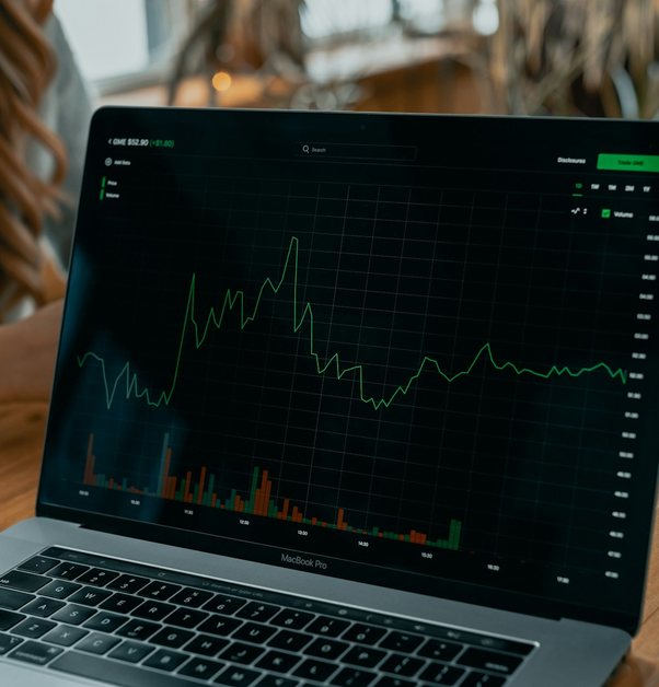 a laptop showing a dark analytics dashboard